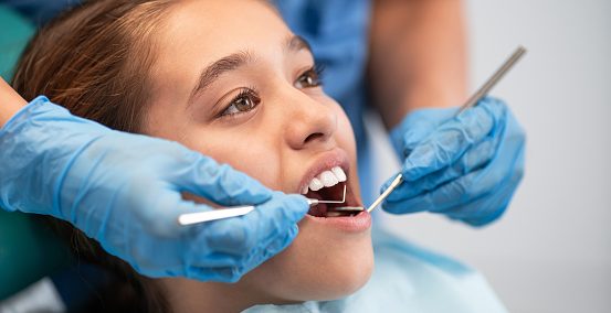 Little girl having a dental exam Little girl having a dental exam